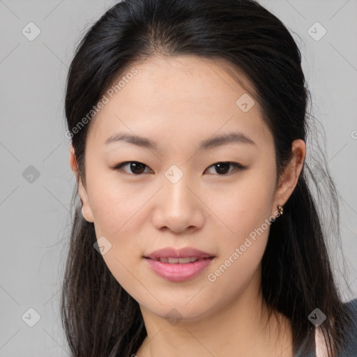 Joyful asian young-adult female with long  brown hair and brown eyes