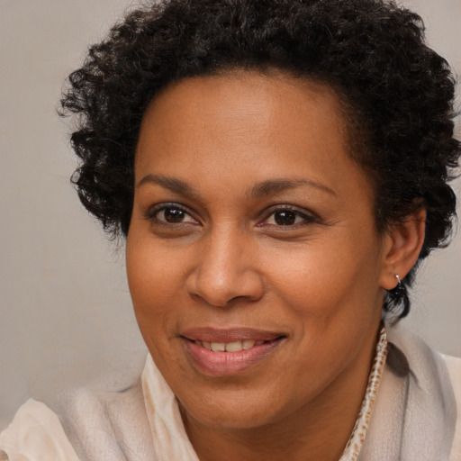 Joyful black adult female with short  brown hair and brown eyes