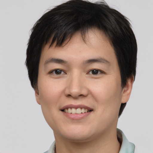 Joyful asian young-adult male with short  brown hair and brown eyes