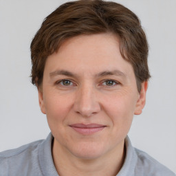 Joyful white adult male with short  brown hair and grey eyes