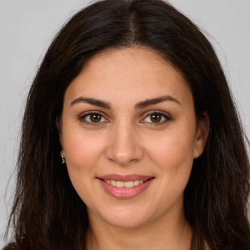 Joyful white young-adult female with long  brown hair and brown eyes