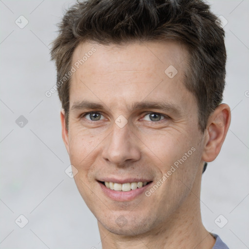 Joyful white adult male with short  brown hair and brown eyes