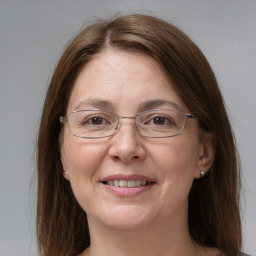 Joyful white adult female with medium  brown hair and grey eyes