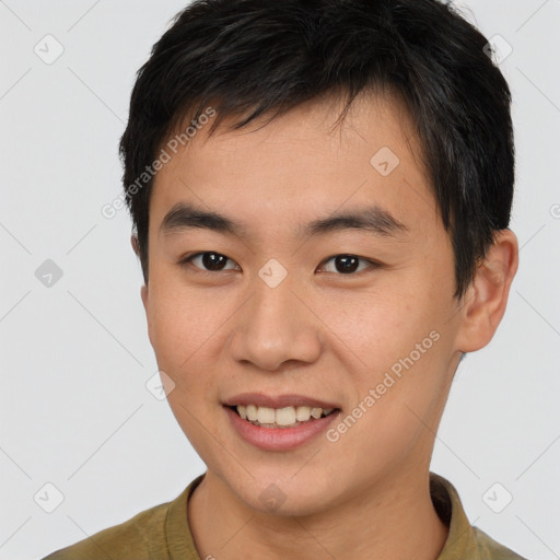 Joyful asian young-adult male with short  brown hair and brown eyes