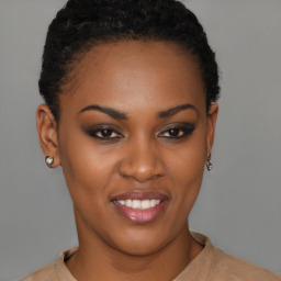Joyful black young-adult female with short  black hair and brown eyes