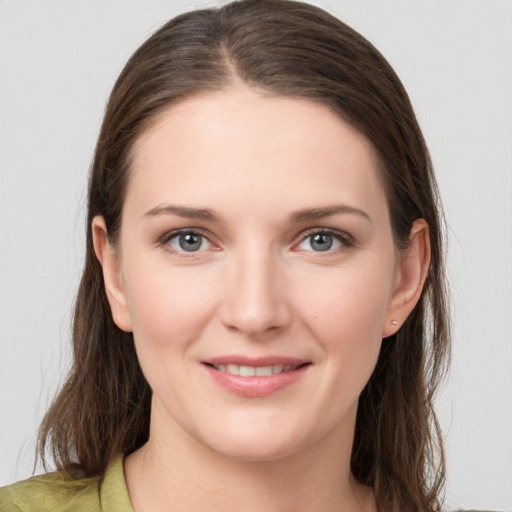 Joyful white young-adult female with medium  brown hair and grey eyes