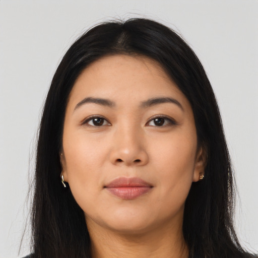 Joyful asian young-adult female with long  brown hair and brown eyes