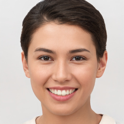 Joyful white young-adult female with short  brown hair and brown eyes