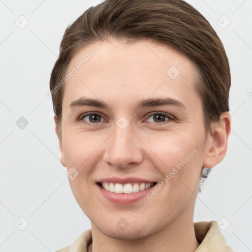 Joyful white young-adult female with short  brown hair and grey eyes