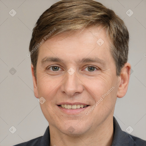 Joyful white adult male with short  brown hair and grey eyes