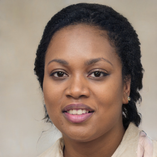 Joyful black young-adult female with long  black hair and brown eyes