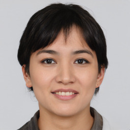 Joyful asian young-adult female with medium  black hair and brown eyes