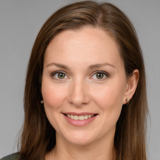 Joyful white young-adult female with long  brown hair and green eyes