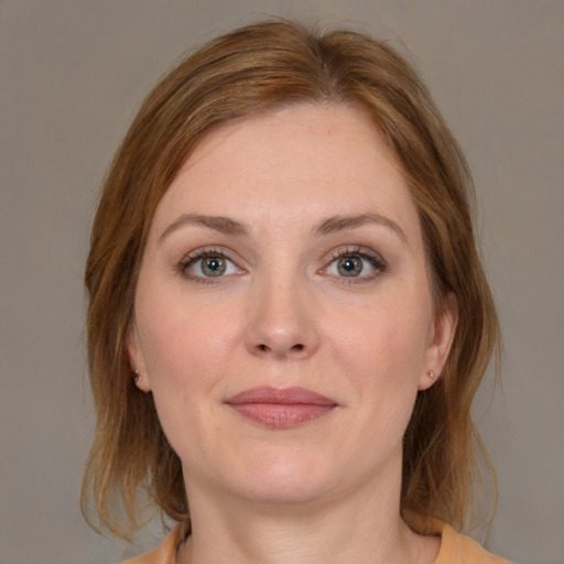 Joyful white young-adult female with medium  brown hair and grey eyes