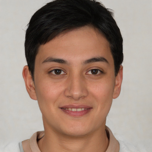 Joyful latino young-adult male with short  brown hair and brown eyes