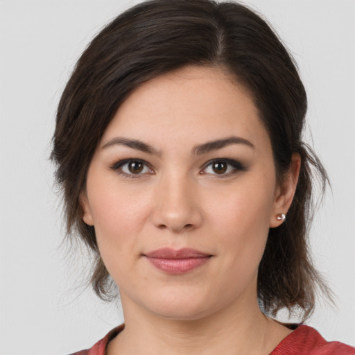 Joyful white young-adult female with medium  brown hair and brown eyes