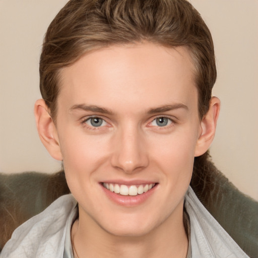 Joyful white young-adult female with short  brown hair and grey eyes