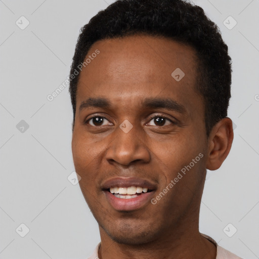 Joyful black young-adult male with short  black hair and brown eyes