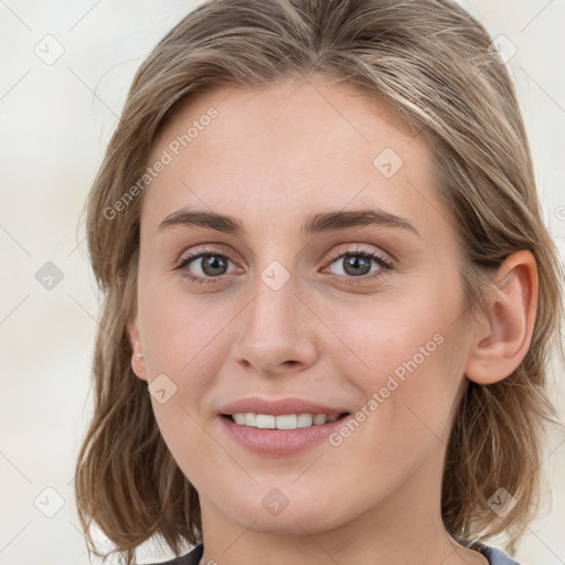 Joyful white young-adult female with medium  brown hair and blue eyes