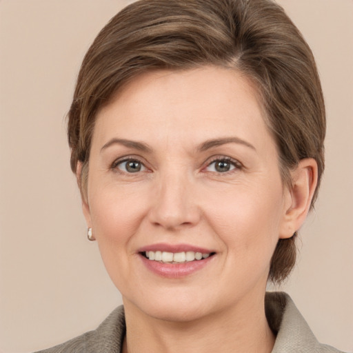 Joyful white adult female with medium  brown hair and grey eyes