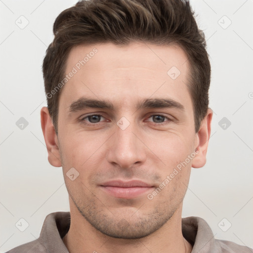 Joyful white young-adult male with short  brown hair and grey eyes