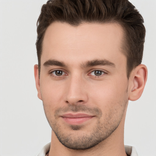 Joyful white young-adult male with short  brown hair and brown eyes