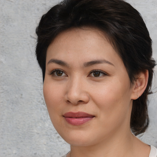 Joyful asian young-adult female with short  brown hair and brown eyes