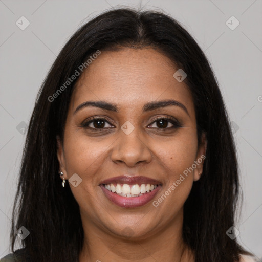 Joyful black young-adult female with long  brown hair and brown eyes