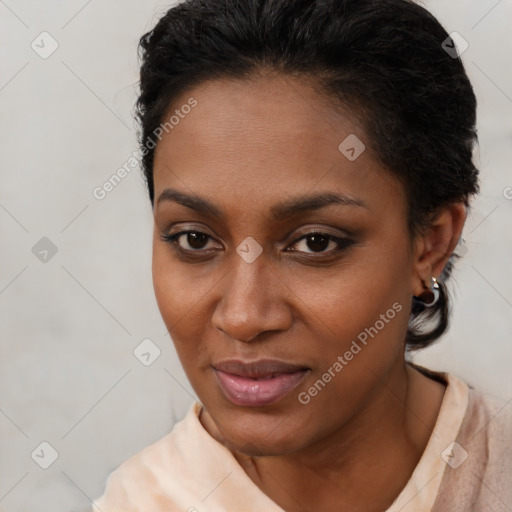 Joyful black young-adult female with short  brown hair and brown eyes