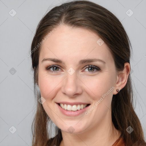 Joyful white young-adult female with long  brown hair and grey eyes