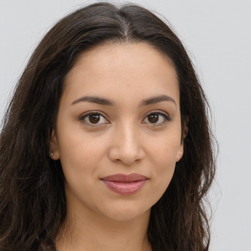 Joyful latino young-adult female with long  brown hair and brown eyes