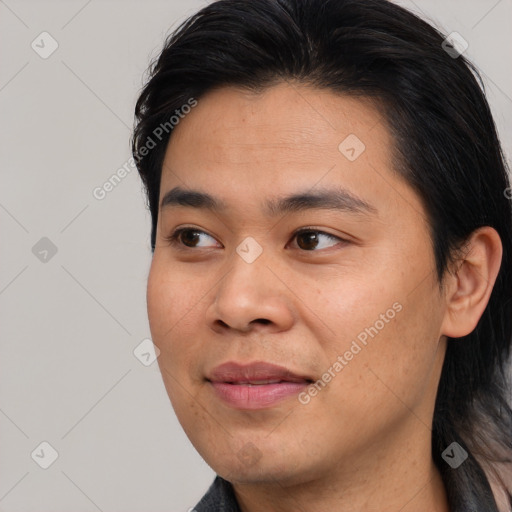 Joyful asian young-adult male with short  brown hair and brown eyes