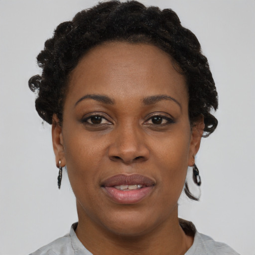 Joyful black adult female with short  brown hair and brown eyes