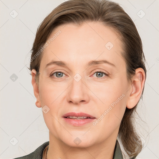 Joyful white adult female with medium  brown hair and grey eyes