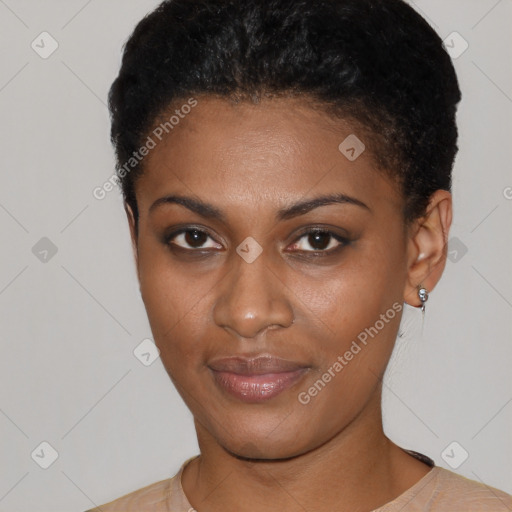 Joyful black young-adult female with short  black hair and brown eyes