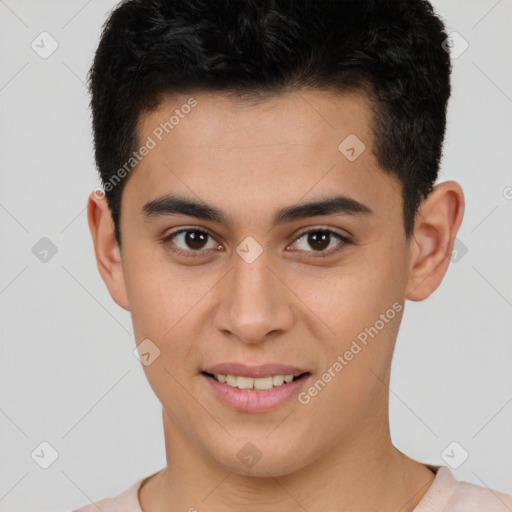 Joyful latino young-adult male with short  brown hair and brown eyes