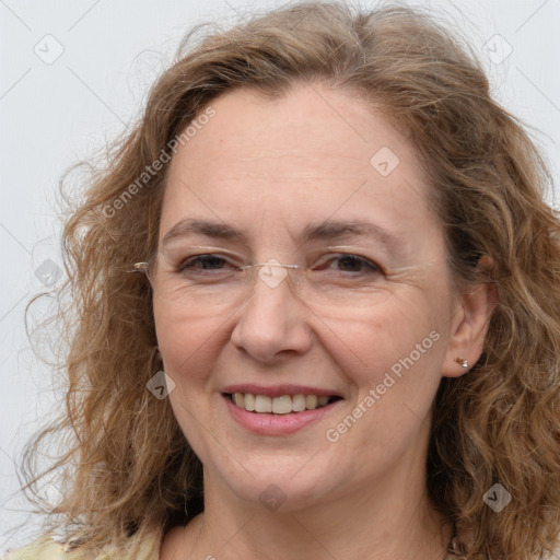 Joyful white adult female with long  brown hair and brown eyes