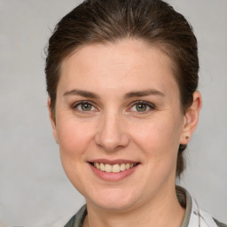 Joyful white young-adult female with medium  brown hair and grey eyes