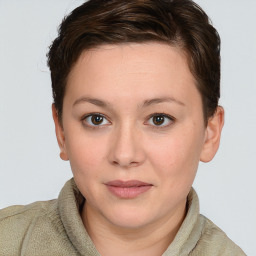 Joyful white young-adult female with short  brown hair and blue eyes