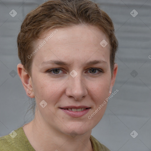 Joyful white young-adult female with short  brown hair and grey eyes