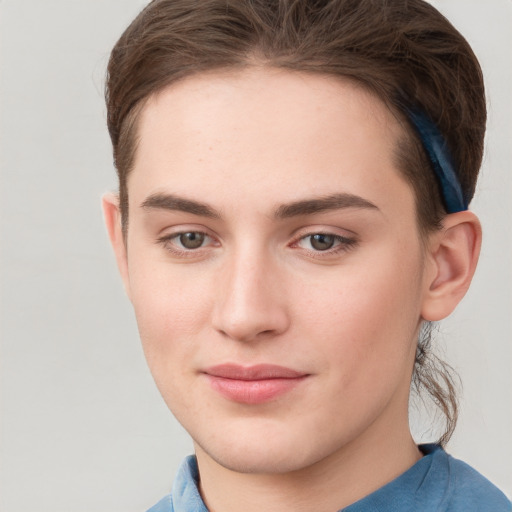 Joyful white young-adult female with short  brown hair and grey eyes