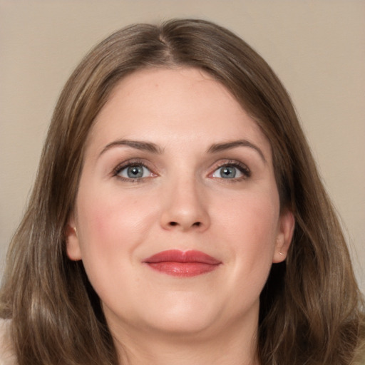 Joyful white young-adult female with long  brown hair and grey eyes