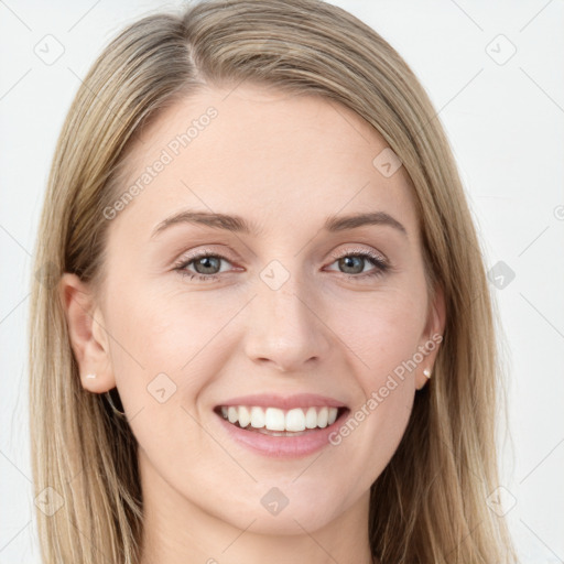 Joyful white young-adult female with long  brown hair and blue eyes