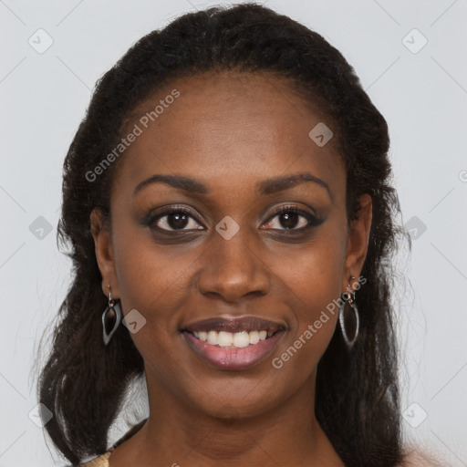 Joyful black young-adult female with long  brown hair and brown eyes