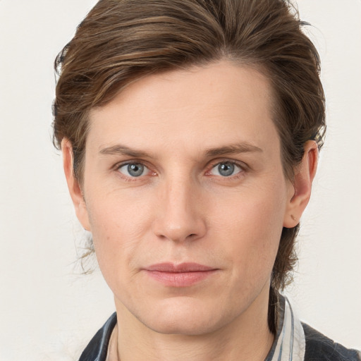 Joyful white young-adult male with medium  brown hair and grey eyes