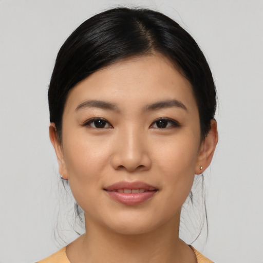 Joyful asian young-adult female with medium  black hair and brown eyes