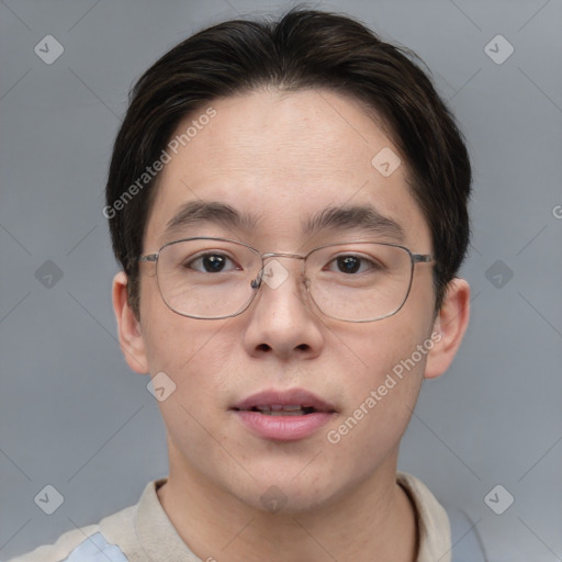 Joyful asian adult male with short  brown hair and brown eyes