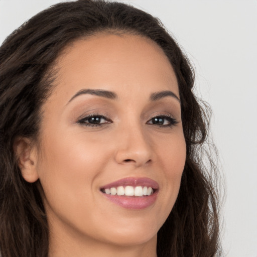 Joyful white young-adult female with long  brown hair and brown eyes