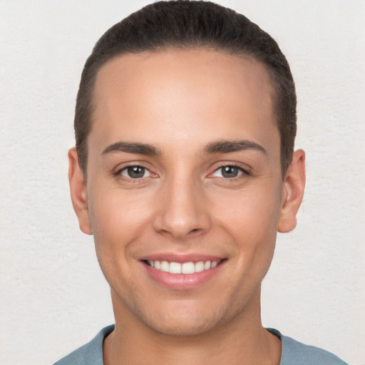 Joyful white young-adult male with short  brown hair and brown eyes