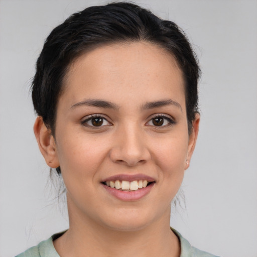 Joyful white young-adult female with short  brown hair and brown eyes